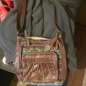 Brown leather The Sac crossbody purse.